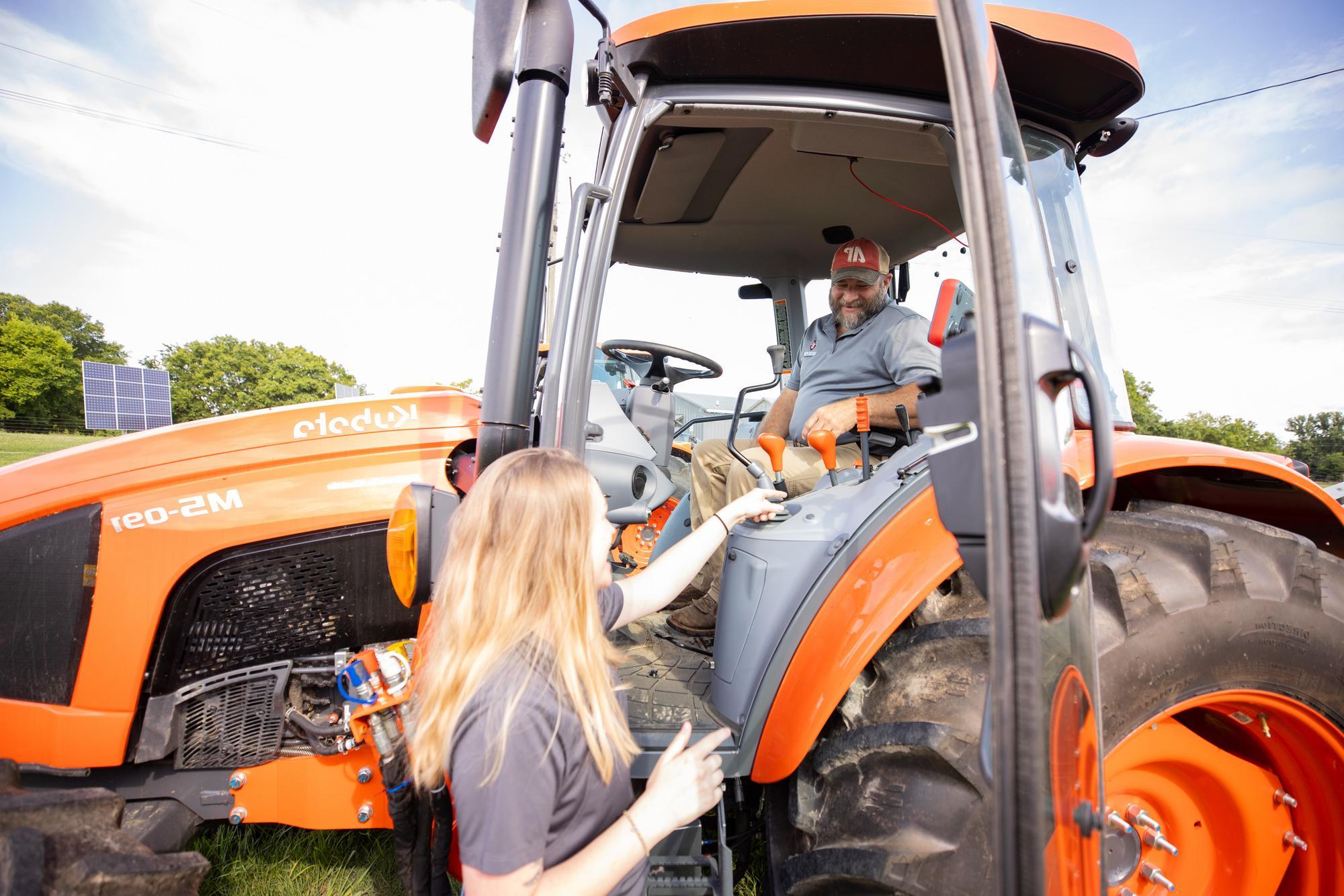 Farm manager sits in tractor